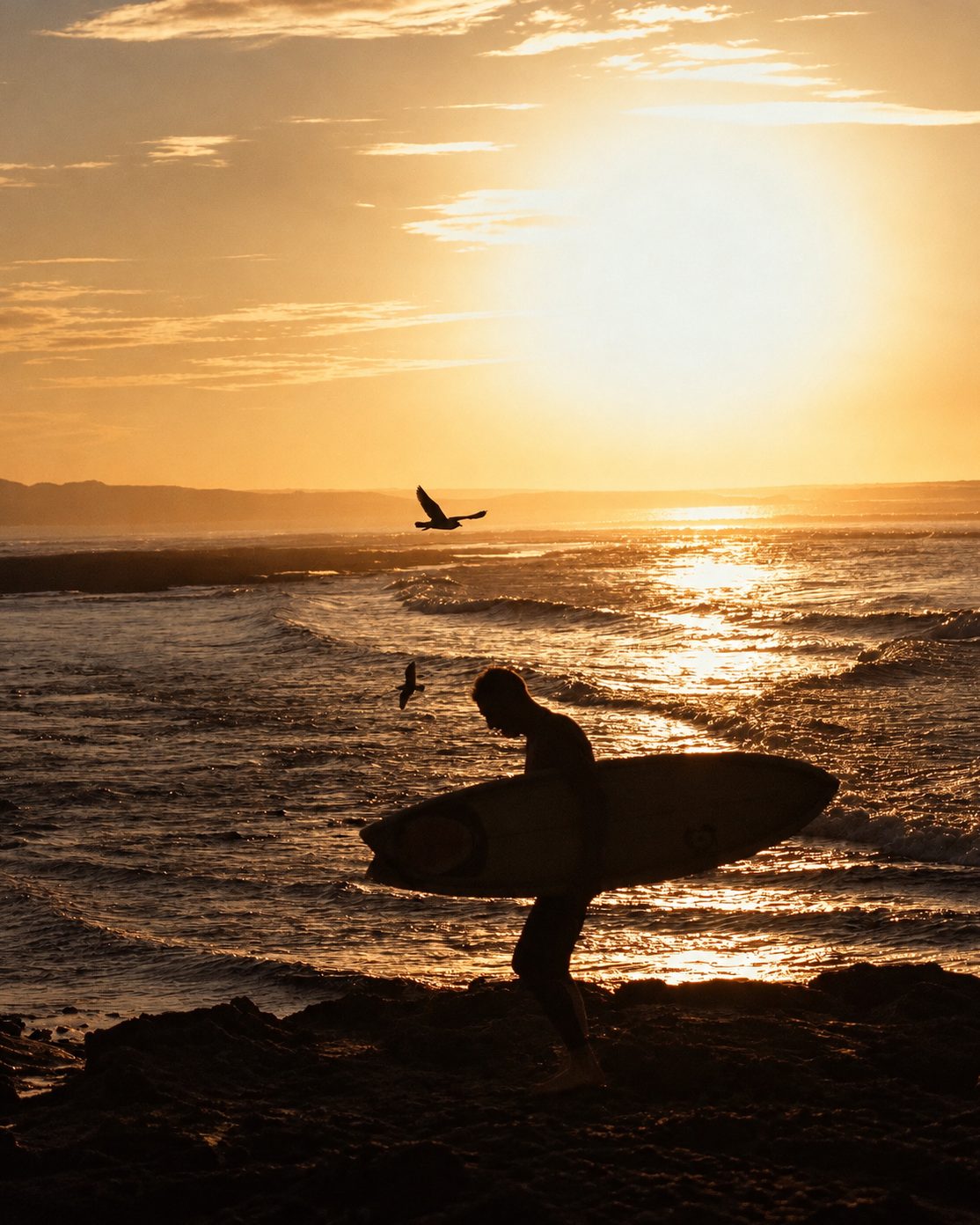 Surfer silhouette at sunset